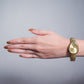 Reloj triangulo ajustable dorado